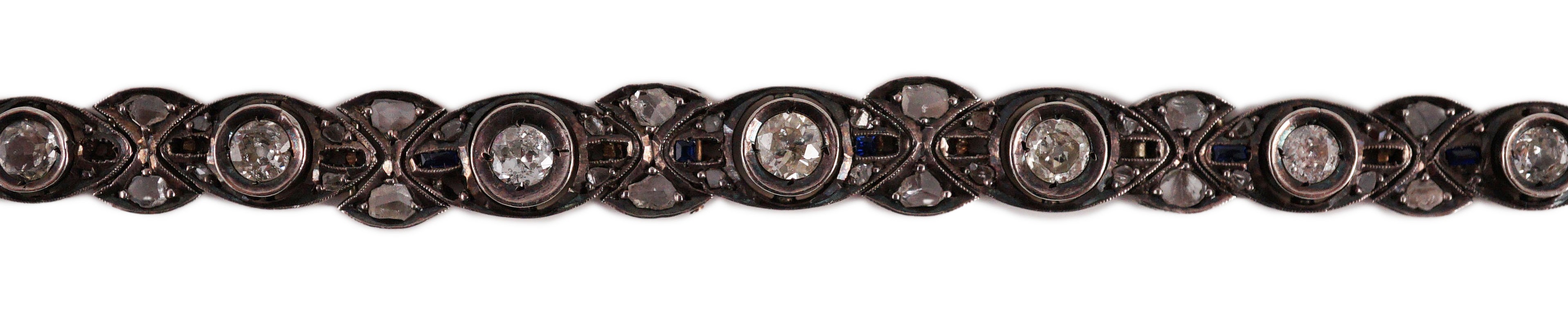 An early to mid 20th century continental gold and silver, graduated diamond and sapphire set line bracelet